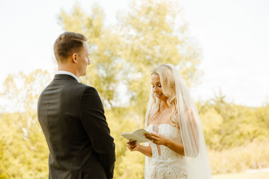 bride and groom exchanging vows during first looks 