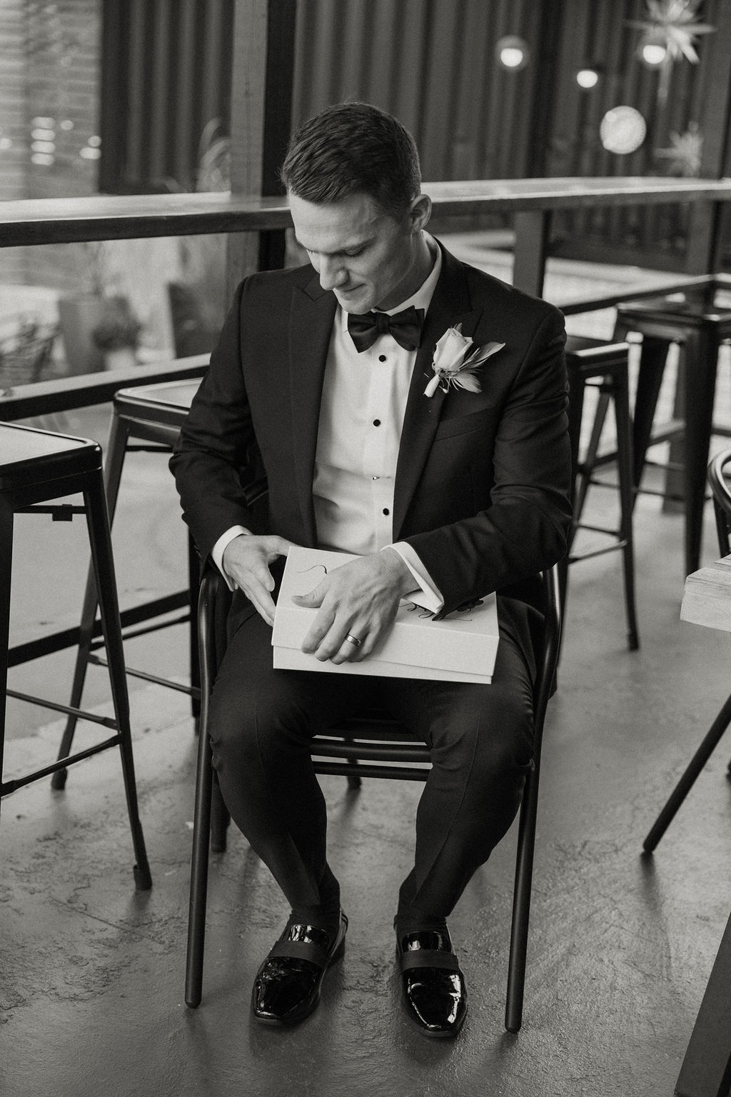groom getting ready for black and white themed wedding