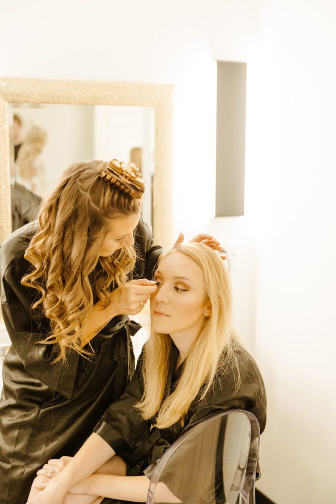 bride getting ready for black and white themed wedding 